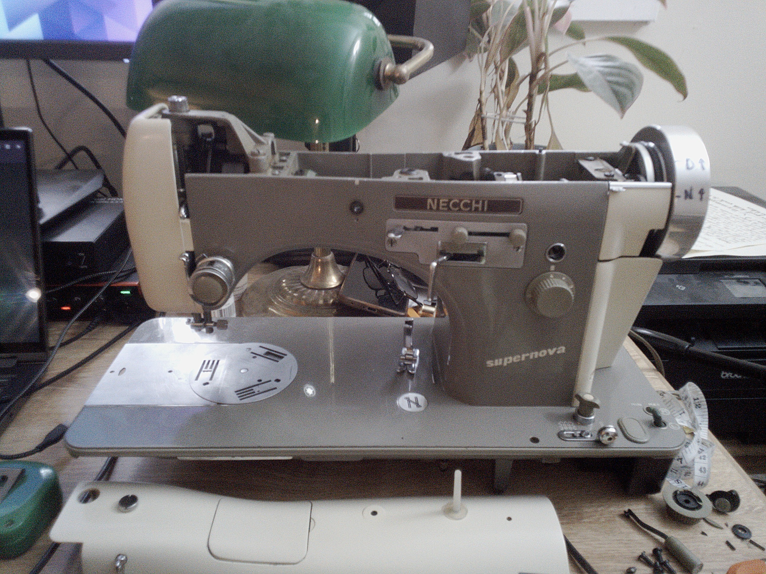 The Necchi Supernova without its embroidery unit, embroidery unit speed knob, and reverse button